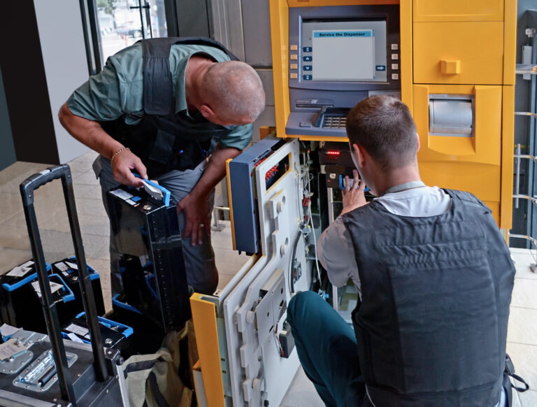 technicians installing an ATM